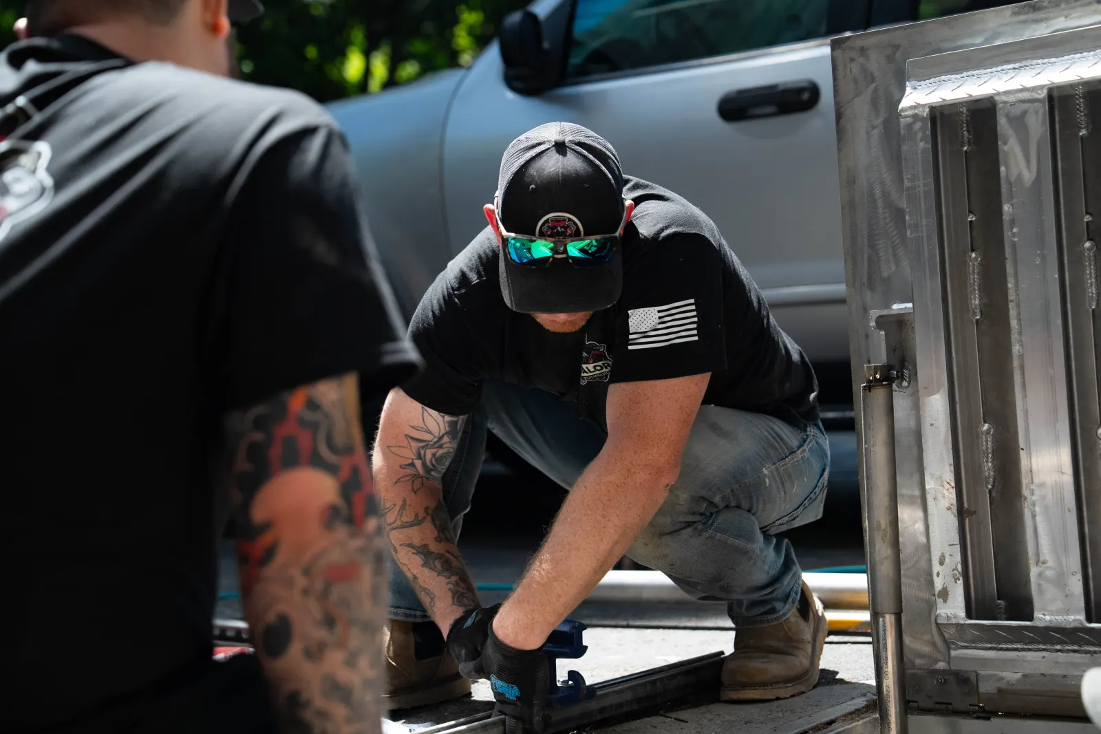 Valor Plumbing plumbers prepping pipe at the back of their work truck